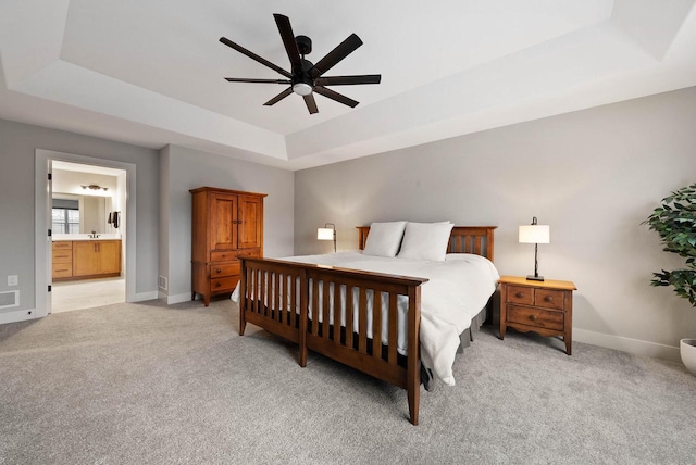 788 Kohlwey Dr, Grafton, WI 53024 - bedroom with a raised ceiling, light colored carpet, baseboards, ensuite bathroom, and a ceiling fan