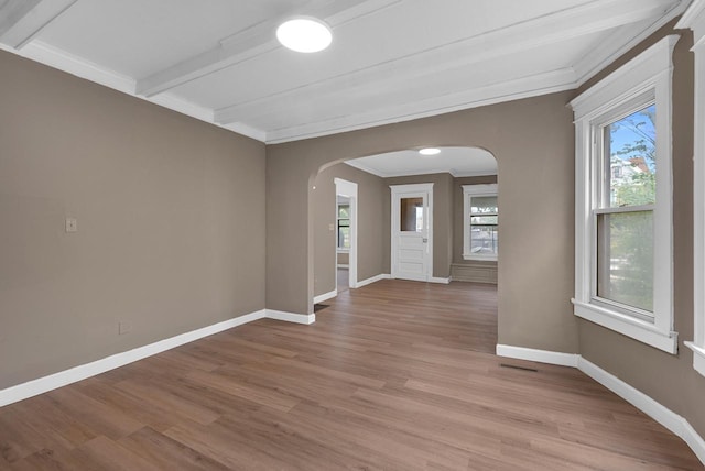 3421 W Clybourn Ave Unit 3423, Milwaukee, WI 53208 - unfurnished room featuring arched walkways, light wood finished floors, baseboards, beam ceiling, and ornamental molding