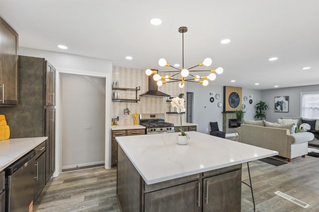 71 Menomonee St, Williams Bay, WI 53191 - kitchen featuring stainless steel appliances, wall chimney exhaust hood, dark wood-style flooring, dark brown cabinetry, and recessed lighting