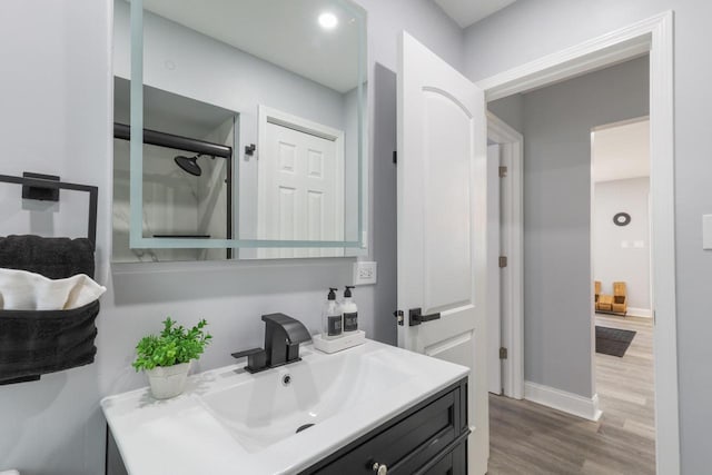 71 Menomonee St, Williams Bay, WI 53191 - full bathroom featuring vanity, wood finished floors, baseboards, and a shower with shower door