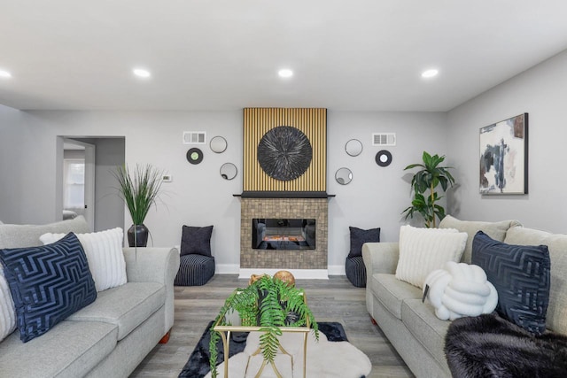 71 Menomonee St, Williams Bay, WI 53191 - living room featuring recessed lighting, a tile fireplace, wood finished floors, and baseboards