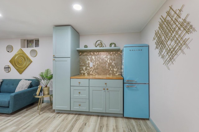 71 Menomonee St, Williams Bay, WI 53191 - kitchen featuring freestanding refrigerator, light wood-style floors, open shelves, decorative backsplash, and ornamental molding