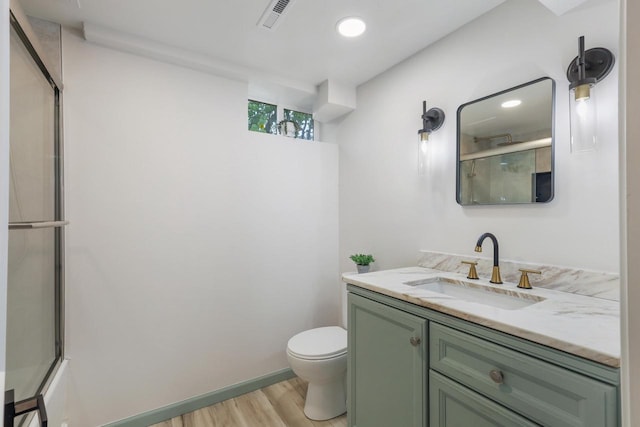 71 Menomonee St, Williams Bay, WI 53191 - bathroom with wood finished floors, toilet, a shower with door, and vanity