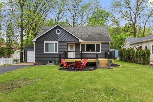 71 Menomonee St, Williams Bay, WI 53191 - bungalow-style house featuring roof with shingles, a deck, and an outbuilding
