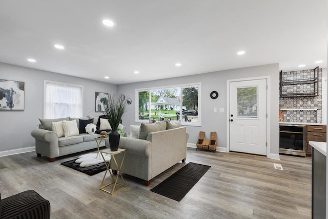 71 Menomonee St, Williams Bay, WI 53191 - living room with wine cooler, a dry bar, recessed lighting, light wood finished floors, and baseboards