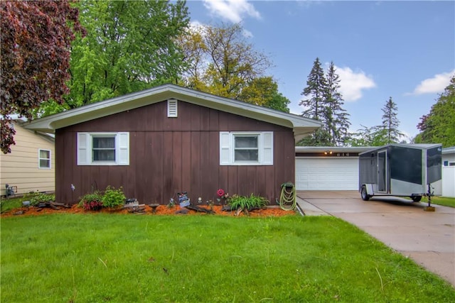 616 E Polk Ave, Eau Claire, WI 54701 - view of front of house with driveway, a garage, a front yard, and board and batten siding