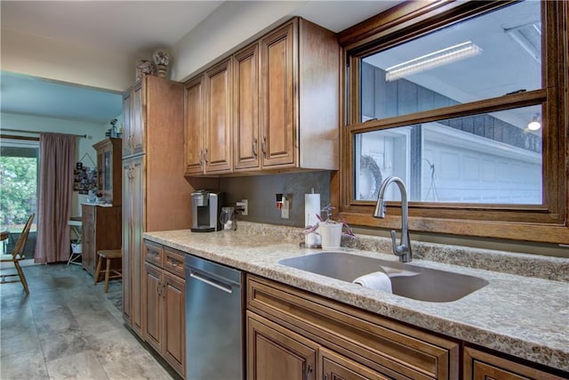 616 E Polk Ave, Eau Claire, WI 54701 - kitchen featuring dishwasher, a sink, brown cabinetry, and light countertops