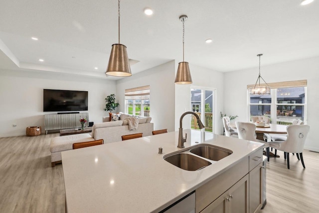 6655 Royal View Dr, Windsor, WI 53532 - kitchen featuring a sink, light wood finished floors, decorative light fixtures, recessed lighting, and a center island with sink
