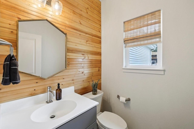 6655 Royal View Dr, Windsor, WI 53532 - bathroom featuring wood walls, vanity, and toilet