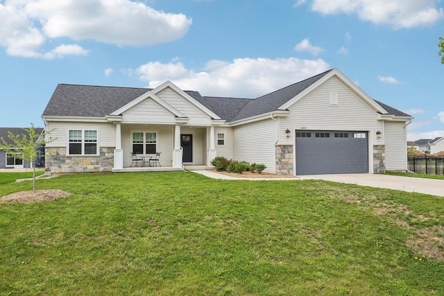 6655 Royal View Dr, Windsor, WI 53532 - craftsman house with a porch, stone siding, concrete driveway, and a shingled roof