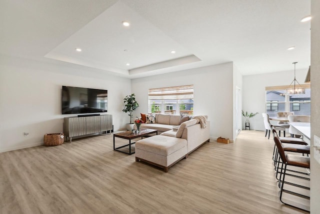 6655 Royal View Dr, Windsor, WI 53532 - living area featuring light wood-style flooring, a chandelier, a tray ceiling, recessed lighting, and baseboards