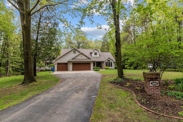 3196 Hidden Pond Rd, Green Bay, WI 54313 - view of front of home with driveway, an attached garage, a front lawn, and a shingled roof