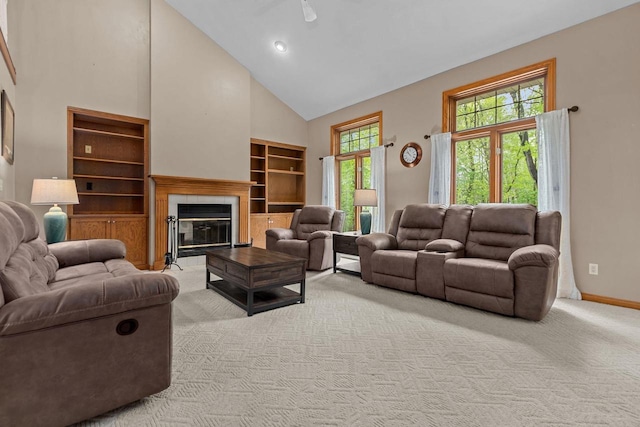 3196 Hidden Pond Rd, Green Bay, WI 54313 - living area featuring high vaulted ceiling, light colored carpet, baseboards, a tiled fireplace, and built in features