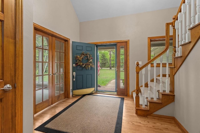 3196 Hidden Pond Rd, Green Bay, WI 54313 - foyer featuring french doors, stairs, light wood-style flooring, high vaulted ceiling, and baseboards