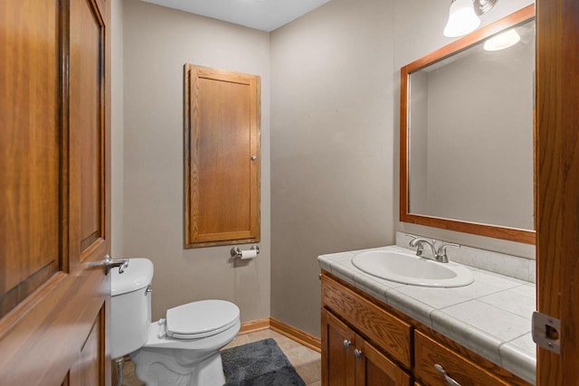 3196 Hidden Pond Rd, Green Bay, WI 54313 - half bath featuring vanity, toilet, tile patterned flooring, and baseboards