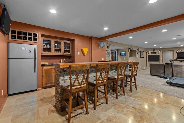 3196 Hidden Pond Rd, Green Bay, WI 54313 - dining area featuring wet bar, baseboards, recessed lighting, and light stone finish flooring