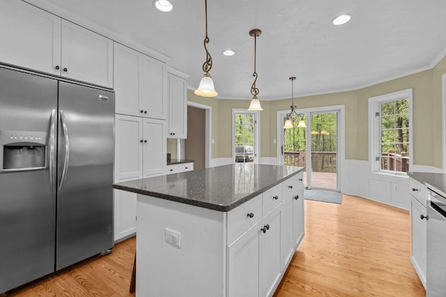 3196 Hidden Pond Rd, Green Bay, WI 54313 - kitchen with stainless steel appliances, white cabinetry, a kitchen island, a wainscoted wall, and recessed lighting