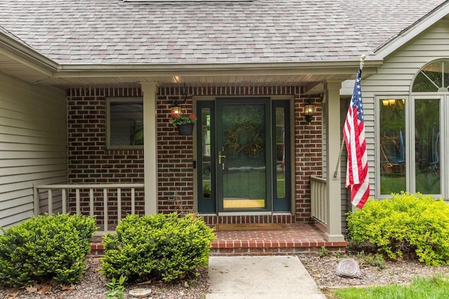 3196 Hidden Pond Rd, Green Bay, WI 54313 - property entrance with roof with shingles, brick siding, and covered porch