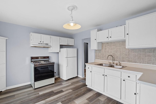 5432 25th Ave, Kenosha, WI 53140 - kitchen with freestanding refrigerator, gas range oven, a sink, under cabinet range hood, and white cabinets
