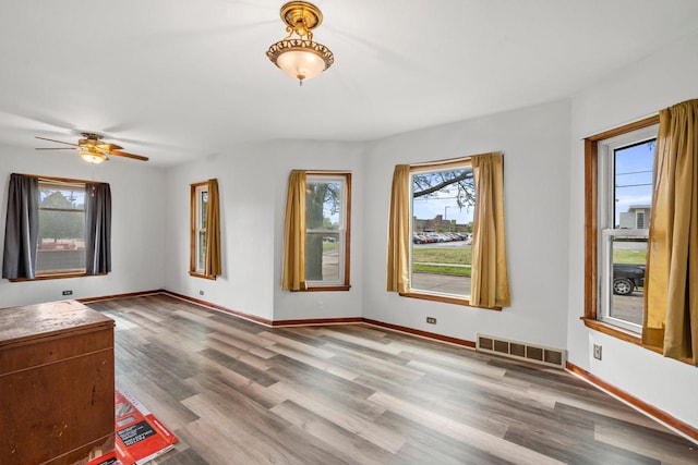 5432 25th Ave, Kenosha, WI 53140 - unfurnished living room featuring wood finished floors, baseboards, and a ceiling fan