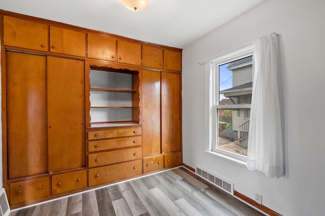 5432 25th Ave, Kenosha, WI 53140 - unfurnished bedroom with light wood finished floors, a closet, and baseboards