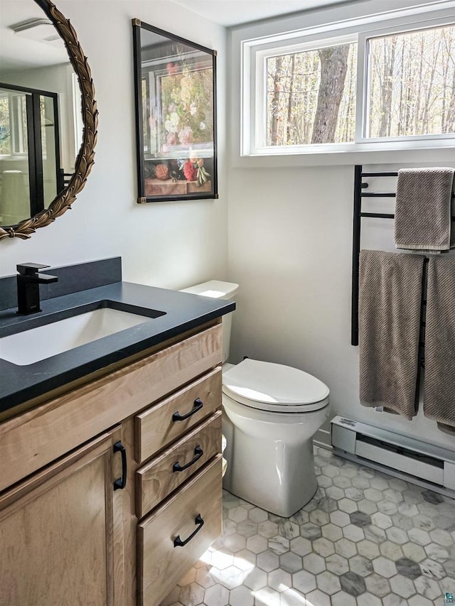 2270 N Shore Rd, La Pointe, WI 54806 - bathroom with a baseboard heating unit, vanity, and toilet