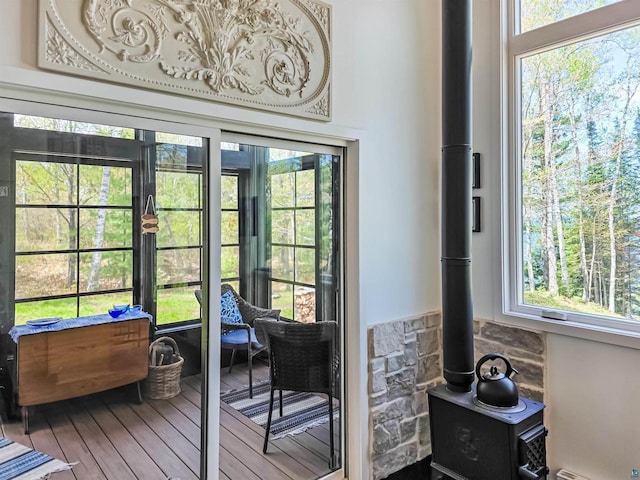 2270 N Shore Rd, La Pointe, WI 54806 - entryway featuring plenty of natural light, a wood stove, wood finished floors, and a baseboard heating unit
