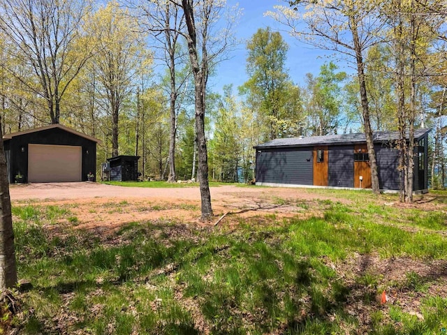 2270 N Shore Rd, La Pointe, WI 54806 - view of yard with an outbuilding, a detached garage, and driveway