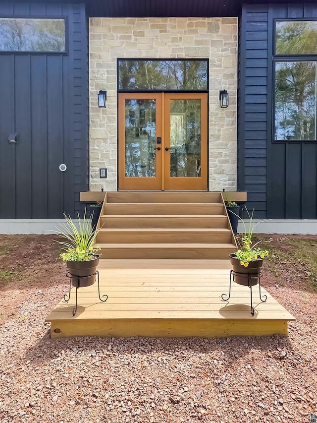 2270 N Shore Rd, La Pointe, WI 54806 - view of exterior entry with french doors, stone siding, and board and batten siding