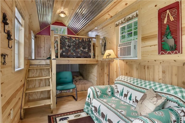 630 W Lake Dr, Shell Lake, WI 54871 - bedroom with wood walls, wood finished floors, vaulted ceiling, and multiple windows