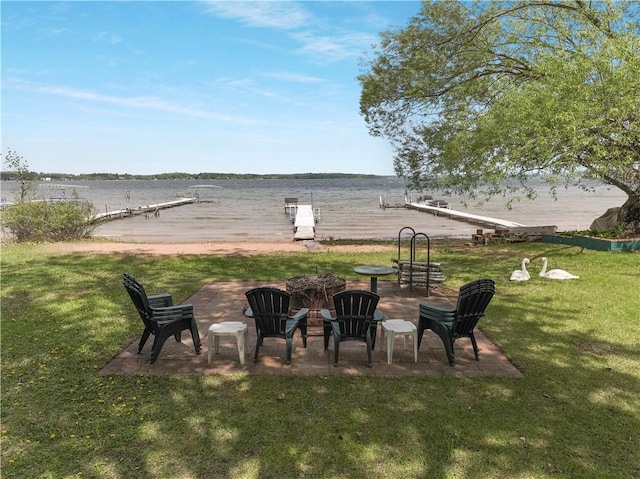 630 W Lake Dr, Shell Lake, WI 54871 - view of green lawn featuring an outdoor fire pit and a water view