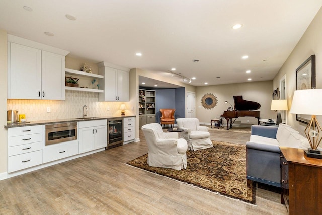 845 Lake Rd Unit D, Brookfield, WI 53005 - living room featuring beverage cooler, light wood finished floors, recessed lighting, and baseboards