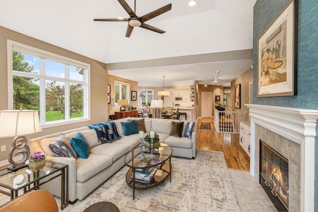 845 Lake Rd Unit D, Brookfield, WI 53005 - living room featuring a ceiling fan, a tile fireplace, a high ceiling, recessed lighting, and light wood-type flooring