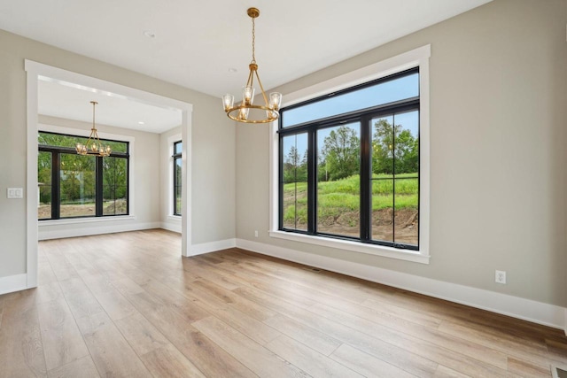 N67W27095 Fanad Dr, Lisbon, WI 53089 - empty room with a chandelier, baseboards, and wood finished floors