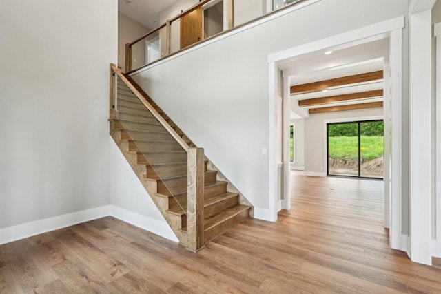 N67W27095 Fanad Dr, Lisbon, WI 53089 - stairs with wood finished floors, baseboards, and beam ceiling