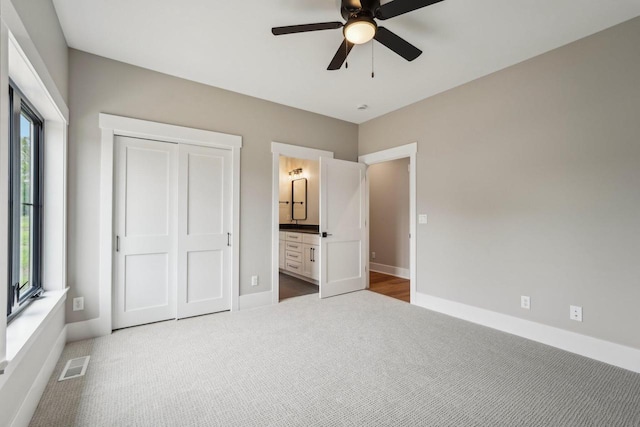 N67W27095 Fanad Dr, Lisbon, WI 53089 - unfurnished bedroom featuring carpet floors, baseboards, a closet, connected bathroom, and a ceiling fan