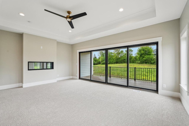 N67W27095 Fanad Dr, Lisbon, WI 53089 - unfurnished room featuring light carpet, a ceiling fan, a tray ceiling, and recessed lighting