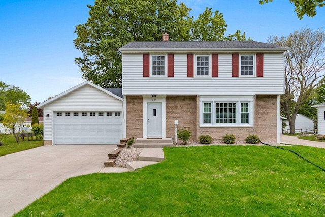 144 Lau St, Green Bay, WI 54302 - colonial-style house with a chimney, a front yard, driveway, and a garage