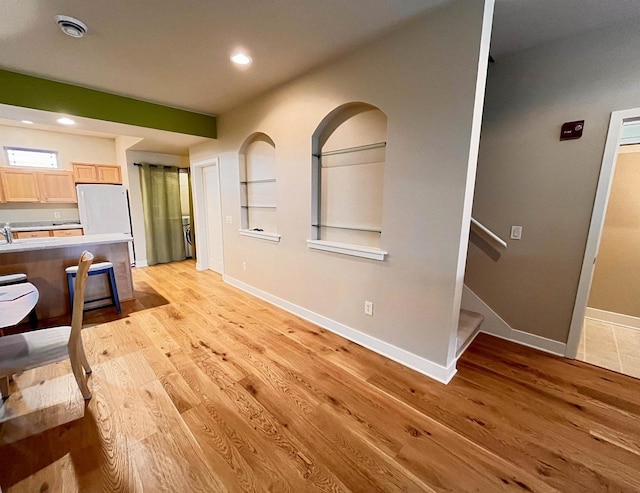 1021 W Pleasant St Unit 5, Portage, WI 53901 - unfurnished living room featuring light wood-type flooring, baseboards, recessed lighting, and stairway