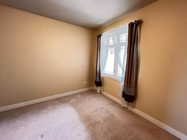1021 W Pleasant St Unit 5, Portage, WI 53901 - unfurnished room with baseboards and light carpet