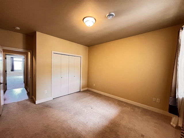 1021 W Pleasant St Unit 5, Portage, WI 53901 - unfurnished bedroom with baseboards, carpet flooring, and a closet