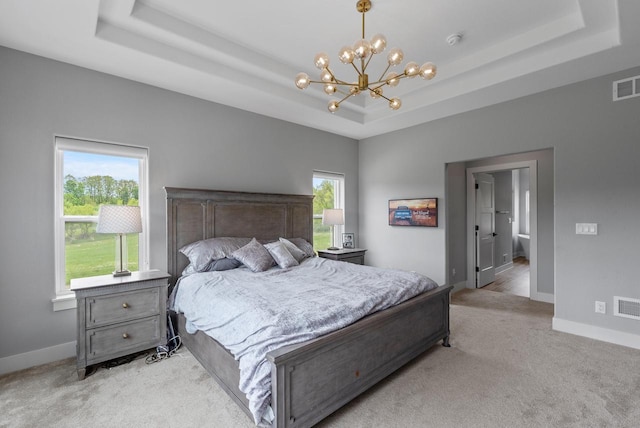 6340 Congress Dr, West Bend, WI 53095 - bedroom featuring a tray ceiling, light carpet, a chandelier, and baseboards