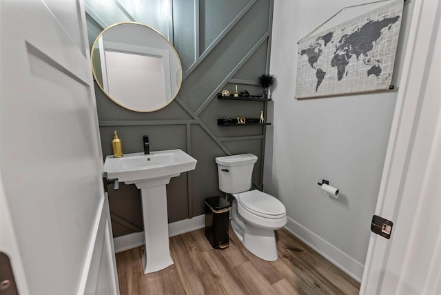 6340 Congress Dr, West Bend, WI 53095 - half bathroom featuring toilet, wood finished floors, and baseboards