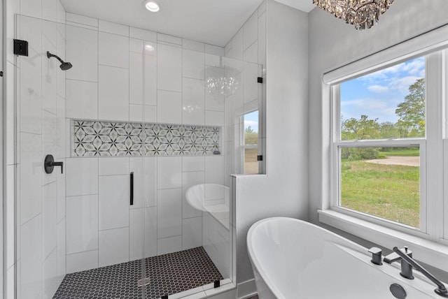 6340 Congress Dr, West Bend, WI 53095 - full bath featuring a shower stall, a freestanding bath, recessed lighting, and a chandelier