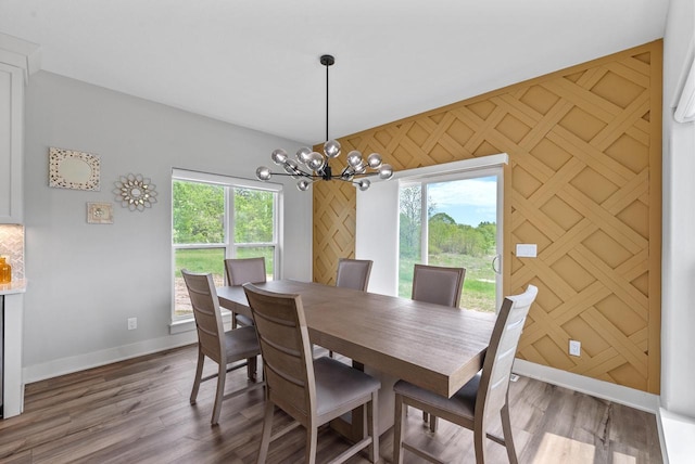 6340 Congress Dr, West Bend, WI 53095 - dining space with baseboards, a chandelier, plenty of natural light, and wood finished floors