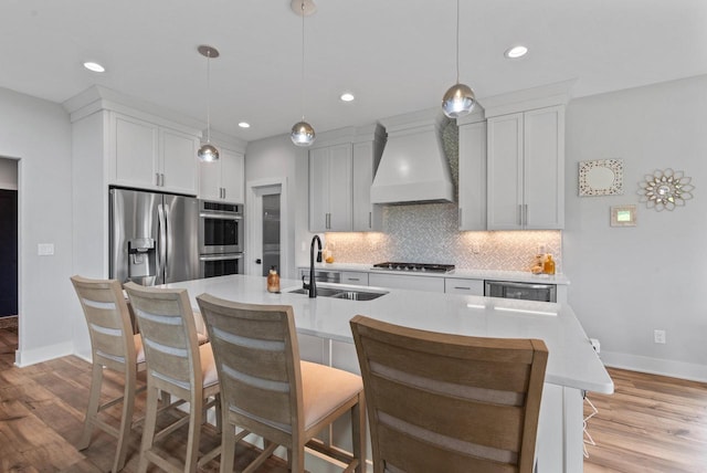 6340 Congress Dr, West Bend, WI 53095 - kitchen featuring appliances with stainless steel finishes, premium range hood, a sink, baseboards, and recessed lighting