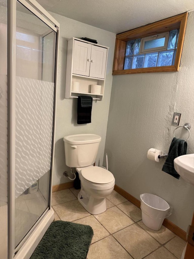2775 S 53rd St, Milwaukee, WI 53219 - full bathroom with a stall shower, toilet, baseboards, and tile patterned floors