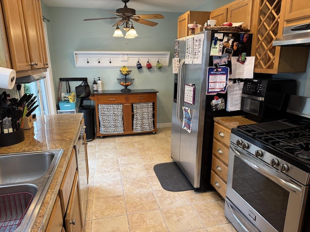 2775 S 53rd St, Milwaukee, WI 53219 - kitchen featuring stainless steel appliances, under cabinet range hood, brown cabinets, a ceiling fan, and a sink