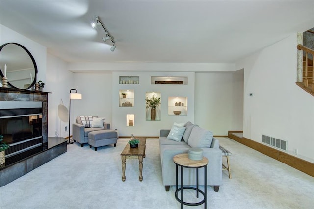 3904 Forest Heights Dr, Eau Claire, WI 54701 - living room featuring carpet flooring, a tile fireplace, and track lighting