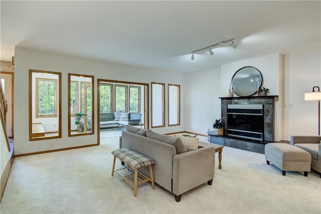 3904 Forest Heights Dr, Eau Claire, WI 54701 - living room featuring light carpet, rail lighting, a fireplace, and baseboards